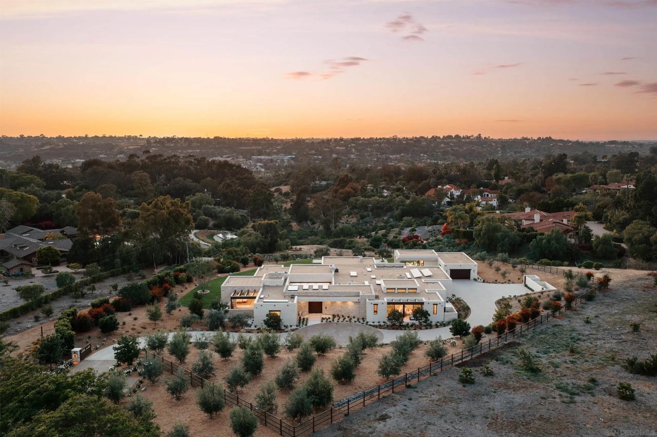 Aerial view of the estate at sunset, with olive groves and pool