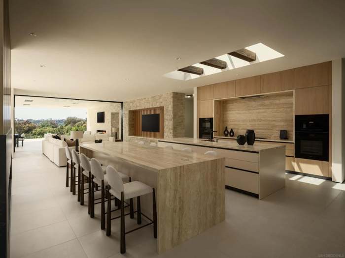 Travertine kitchen island with skylights and seating for eight
