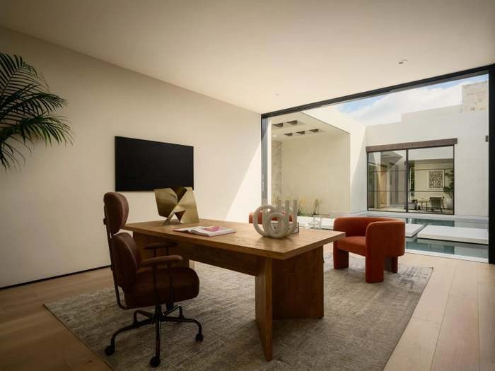 Study with wood desk and views onto the courtyard pool