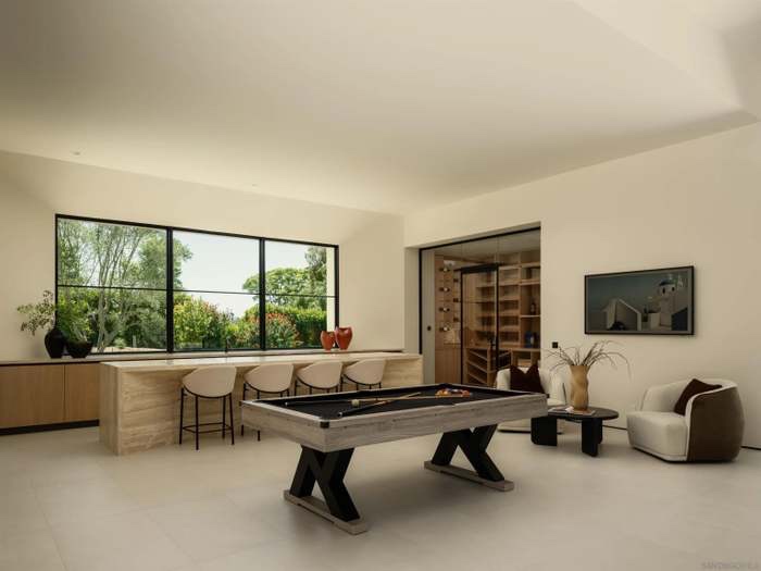 Billiards room with travertine bar and mountain view