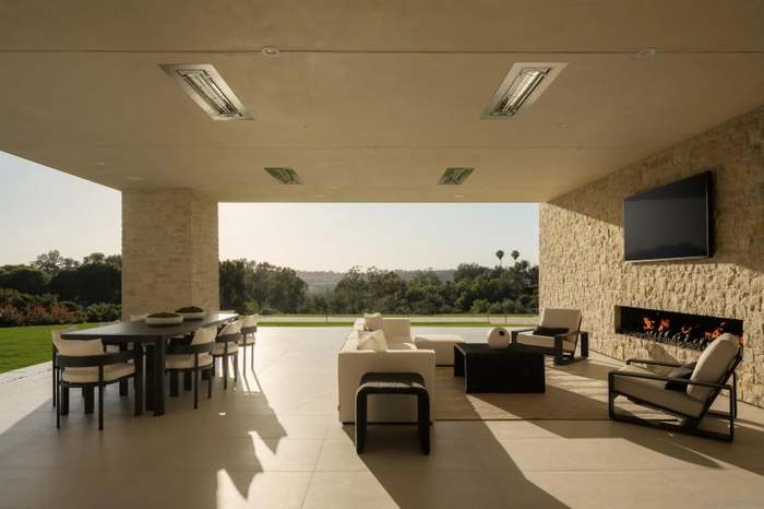 Covered outdoor dining pavilion with fireplace and long views