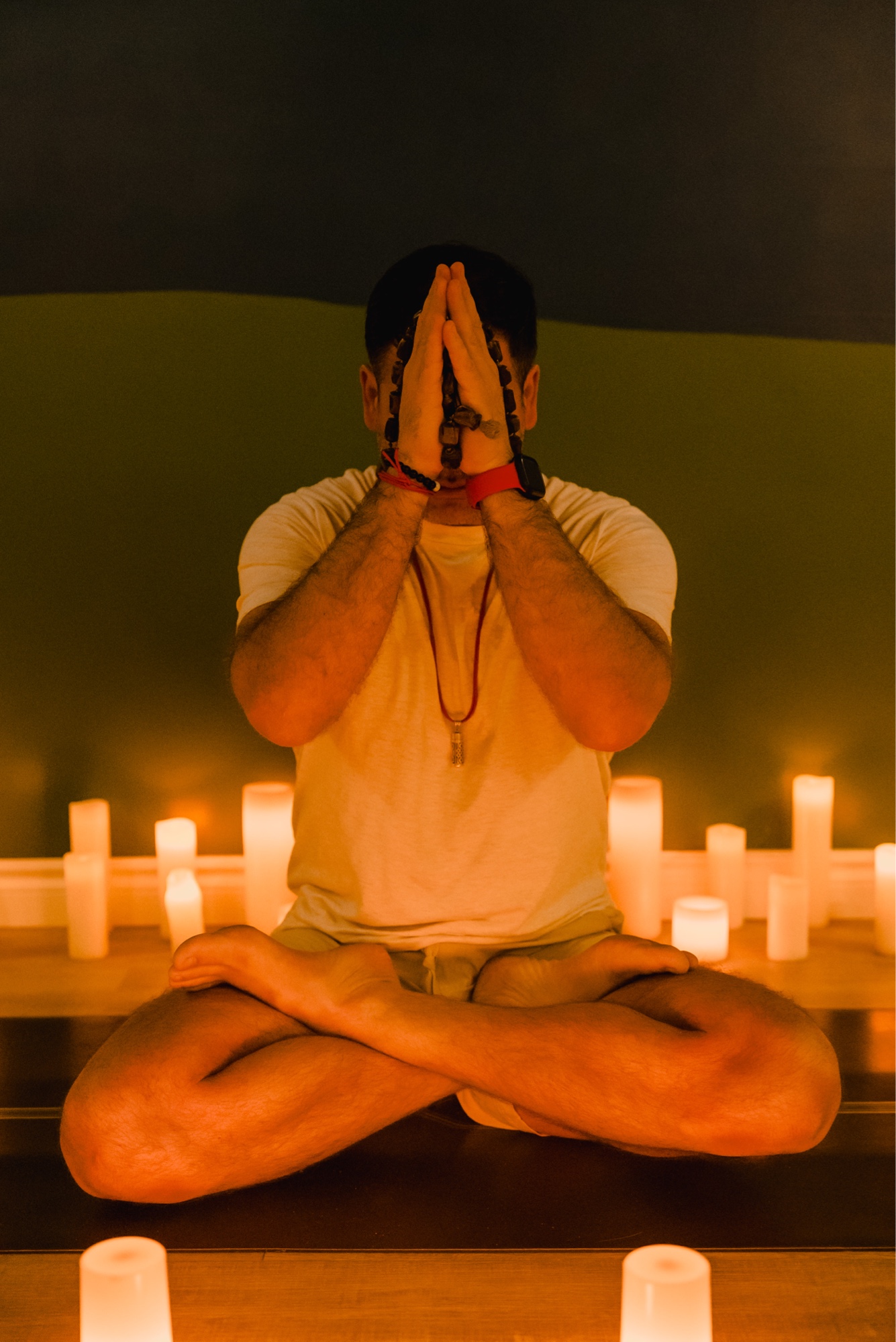 Markandeya Rsi in seated meditation surrounded by candlelight