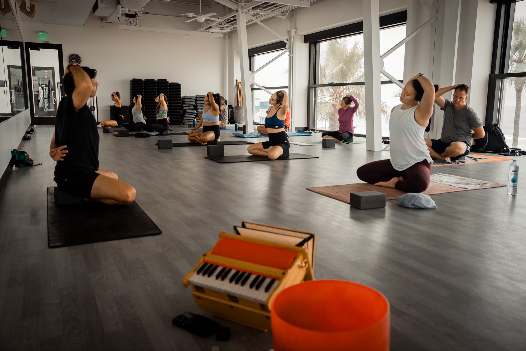 Markandeya Rsi leading a yoga class with harmonium and singing bowl
